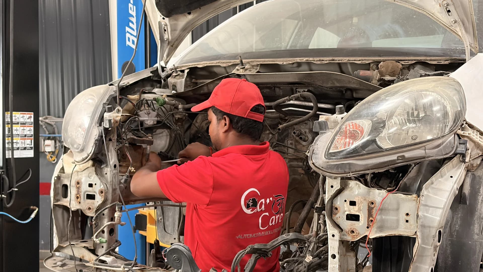 THE CAR O CARE technician repairing the front end of a vehicle in the workshop